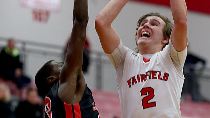 Fairfield guard Drew O’Donnell shoots while being covered by Colerain’s Cass Carter during their game at Fairfield Arena on Tuesday night. CONTRIBUTED PHOTO BY E.L. HUBBARD