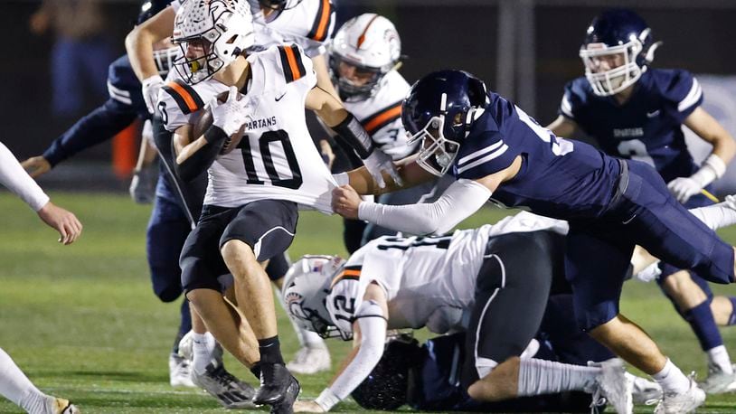 Valley View's Bryce Reed tries to bring down Waynesville's Garrett Lundy during their playoff game at Spingboro Friday, Nov. 17, 2023. BILL LACKEY/STAFF