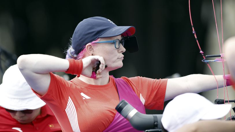 Britain's Jodie Grinham releases an arrow during the Paralympic Games in Paris on Thursday, Aug. 29, 2024. The British archer is competing while pregnant. (AP Photo/Felix Scheyer)