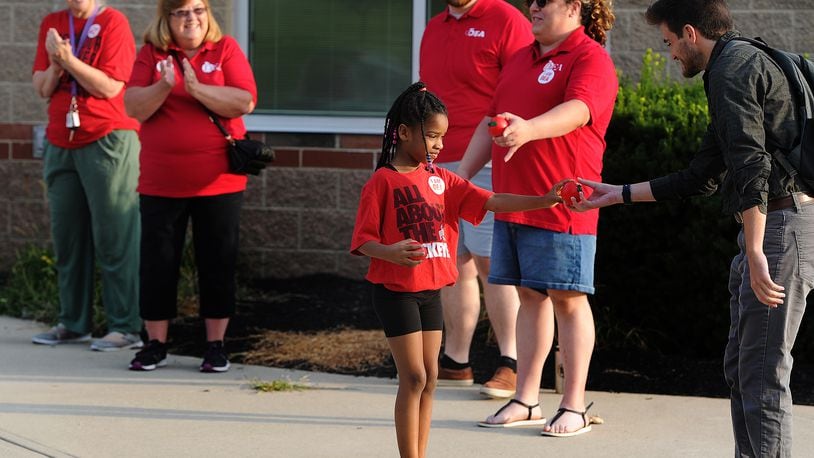 Kaliyah Williams, age 6, helps the Dayton teachers union members clap in first year teachers Thursday, Aug. 3, 2023 at Thurgood Marshall High School. MARSHALL GORBY\STAFF