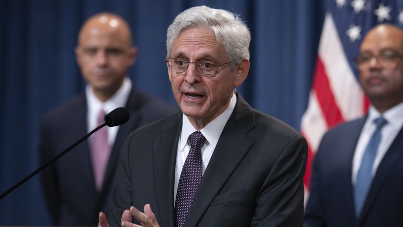 Attorney General Merrick Garland, flanked by Matt Graves, U.S. attorney for the District of Columbia, left, and Ronald Davis, director of the United States Marshals Service, holds a news conference as the Justice Department announced criminal charges against Iranian operatives suspected of hacking Donald Trump's presidential campaign and disseminating stolen information to media organizations, at the Justice Department in Washington, Friday, Sept. 27, 2024. (AP Photo/J. Scott Applewhite)