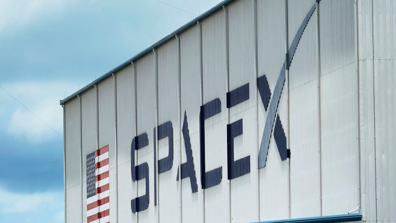 FILE - The SpaceX logo is displayed on a building, Tuesday, May 26, 2020, at the Kennedy Space Center in Cape Canaveral, Fla. (AP Photo/David J. Phillip, File)