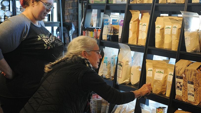 Samantha Lange, left, with Rosebud's Real Food at the 2nd Street Market helps Catherine Hackett with her shopping Friday, Dec. 15, 2023. MARSHALL GORBY\STAFF