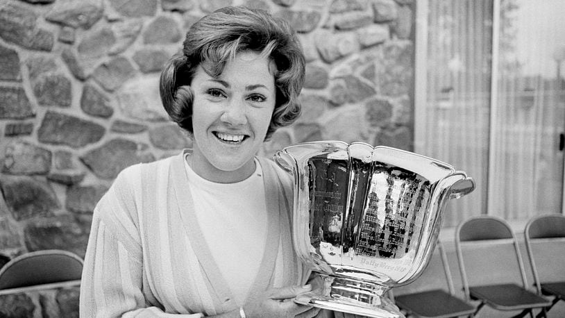 FILE - Susie Maxwell holds the silver trophy after winning the 36th annual Women's Western golf tournament, June 14, 1965, in Chicago. (AP Photo/Larry Stoddard, File)