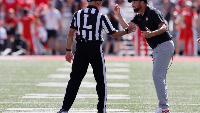 Ohio State head coach Ryan Day, right, argues with the linesman during the second half of an NCAA college football game against Marshall, Saturday, Sept. 21, 2024, in Columbus, Ohio. (AP Photo/Jay LaPrete)