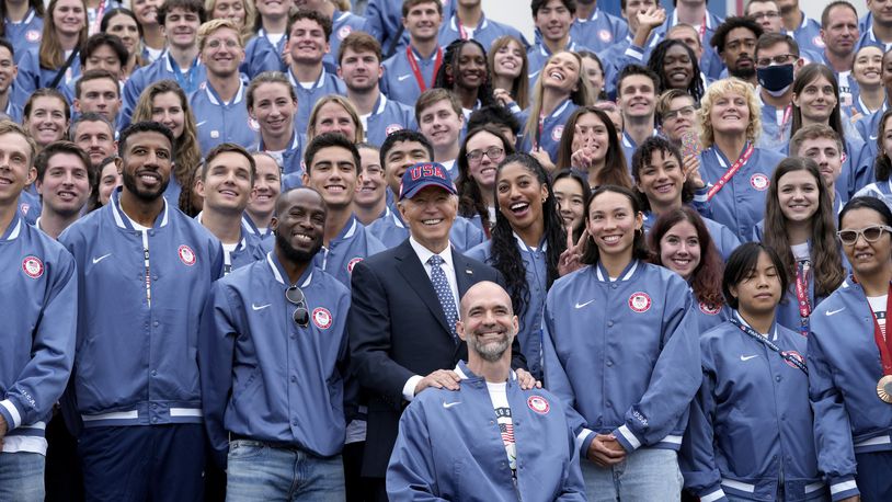 President Joe Biden, front row center, takes a photo with attendees at an event celebrating the 2024 U.S. Olympic and Paralympic teams on the South Lawn of the White House in Washington, Monday, Sept. 30, 2024. (AP Photo/Susan Walsh)