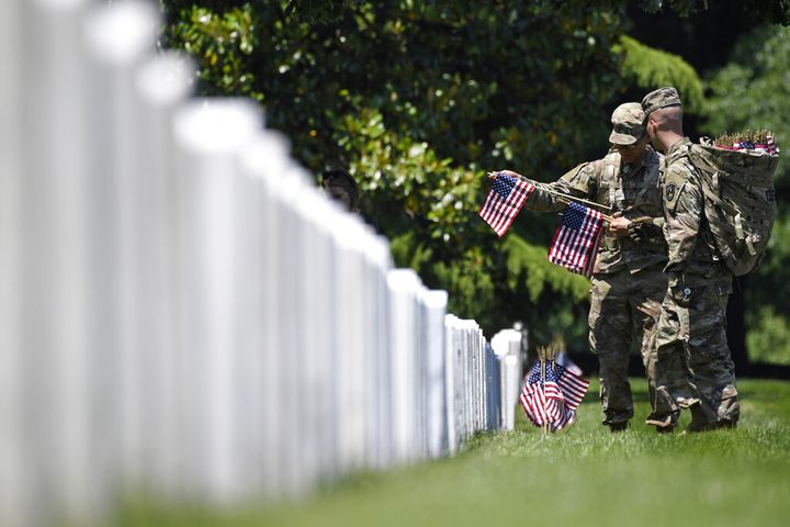 Soldiers place flags at Arlington National Cemetery for Memorial Day