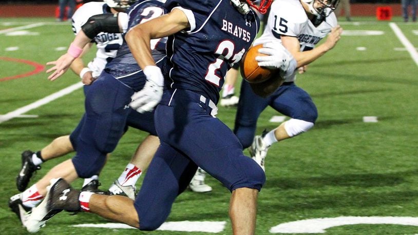 Talawanda running back Maurice Thomas (21) runs for his second touchdown in Friday night’s game against Edgewood at Talawanda High School in Oxford Oct. 18, 2013. NICK DAGGY / STAFF