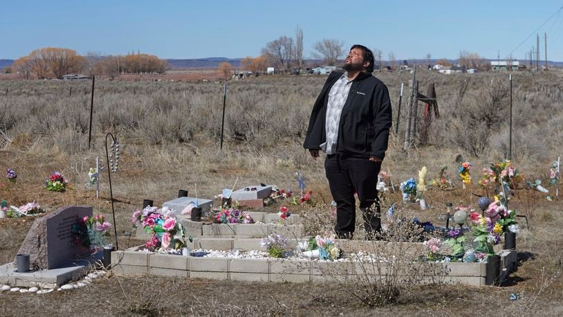 Shoshone-Paiute tribal member Michael Hanchor visits his mother’s grave, March 15, 2024, in Owyhee, Nev., on the Duck Valley Indian Reservation that straddles the Nevada-Idaho border. (AP Photo/Rick Bowmer)