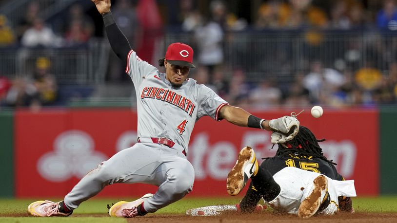 Pittsburgh Pirates' Oneil Cruz, right, steals second base as Cincinnati Reds second baseman Santiago Espinal, left, attempts to field the ball during the fifth inning of a baseball game, Thursday, Aug. 22, 2024, in Pittsburgh. (AP Photo/Matt Freed)