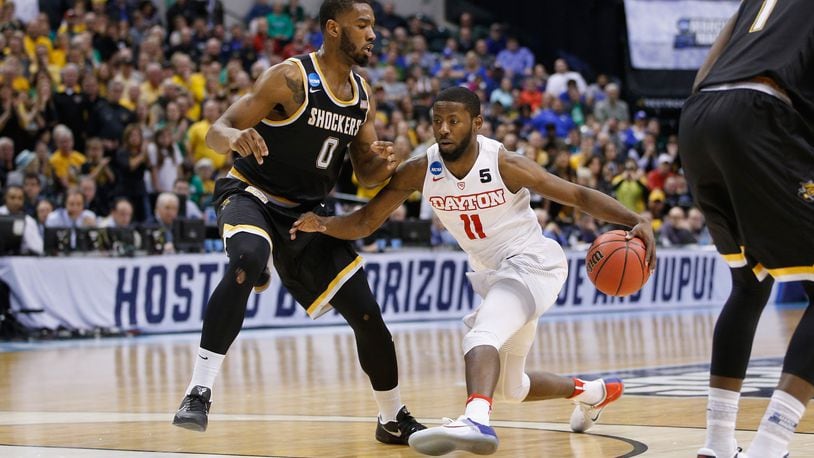 Scoochie Smith of the Dayton Flyers dribbles against Rashard Kelly of the Wichita State Shockers during the first round of the 2017 NCAA Men's Basketball Tournament at Bankers Life Fieldhouse on March 17, 2017 in Indianapolis, Indiana.