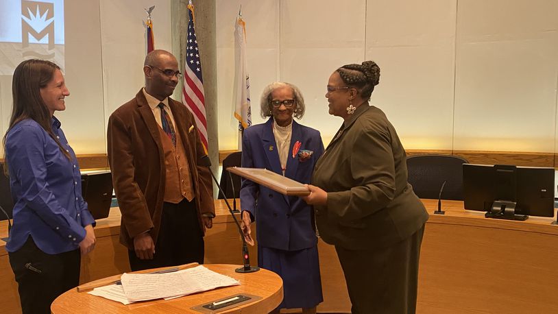 Celeste Didlick-Davis, right, accepts the 14th Robert "Sonny" Hill Jr. Humanitarian Award from, left, Middletown Mayor Nicole Condrey, Robbie Hill and Pat Hill. She received the award at the last city council meeting. RICK McCRABB/STAFF