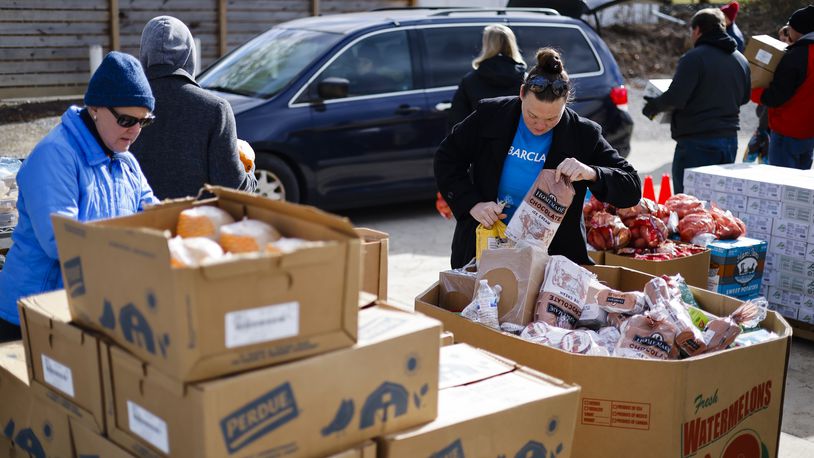 Volunteers and employees at Shared Harvest food Bank distribute food for around 250 families Friday, Nov. 18, 2022 in Fairfield. NICK GRAHAM/STAFF