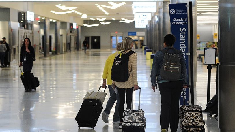 Travelers at the Dayton International Airport. MARSHALL GORBY\STAFF