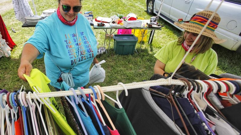 Rebekah Church, left, and Vickie Church, 12, from Cincinnati, try to find deals at the 127 yard sale Friday, Aug. 7, 2020. They went to Kentucky Thursday and plan to make is into northern Ohio today. The 127 corridor yard sale, dubbed the world's largest yard sale, is going on now through Sunday, Aug. 9 along U.S. 127 from Michigan to Alabama. This spot between New Miami and Seven Mile has multiple vendors displaying their bargains. NICK GRAHAM/STAFF