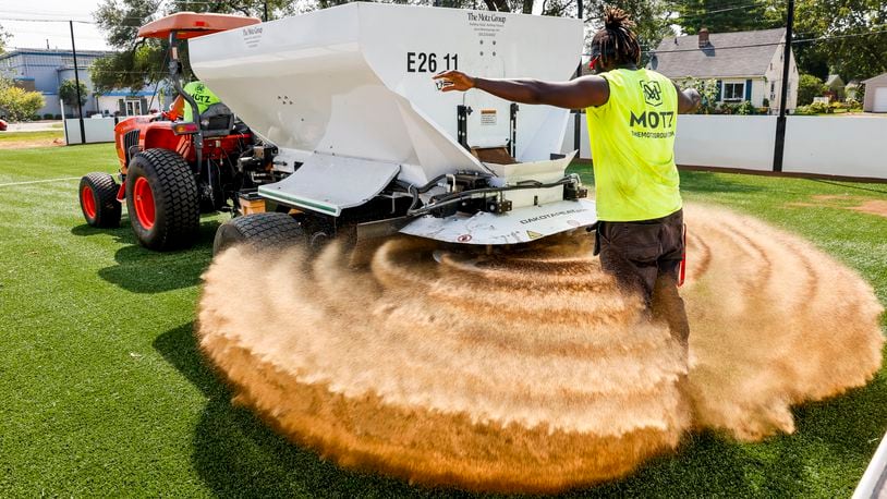 Robert Scott with Motz Group works on a installing a miniature turf soccer field at Douglass Park Wednesday, Aug. 23, 2023 in Middletown. NICK GRAHAM/STAFF