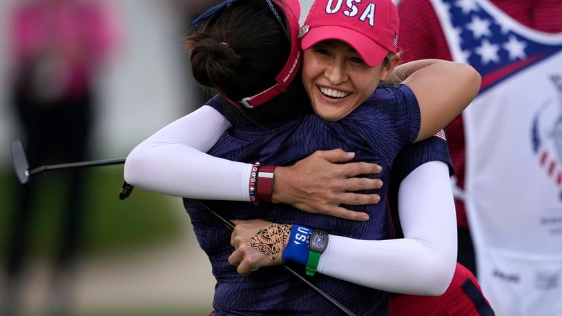 United States' Nelly Korda, right, and teammate Megan Khang hug while celebrating their victory during a Solheim Cup golf tournament fourball match at Robert Trent Jones Golf Club, Friday, Sept. 13, 2024, in Gainesville, Va. (AP Photo/Matt York)