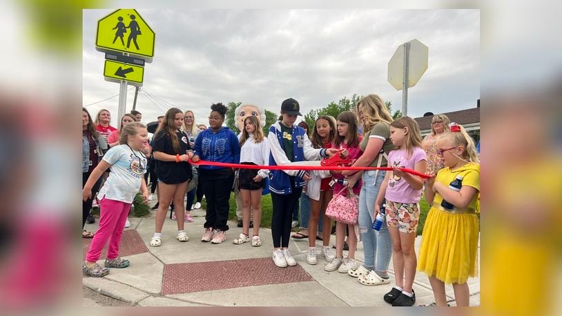 City of Hamilton officials, Lindenwald residents and Linden Elementary students and staff members celebrated Friday morning the completion of the sidewalk and flashing crosswalk project at the intersection of St. Clair and Van Hook avenues. CHRIS VOGT/CONTRIBUTOR