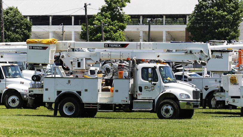 Duke Energy crews are seen in Hamilton in June 2022 after a power outage from a big storm that swept through the region. NICK GRAHAM/FILE