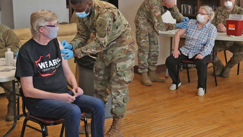 National Guard members give senior residents at Shawnee Place Apartments a COVID vaccine shot Thursday, March 4, 2021, during a clinic set up at the apartments. The clinic is a cooperative effort between the National Guard, the Area Agency on Aging and the Clark County Combined Health District to bring the vaccine to seniors who may not be able to make it to the Clark County clinic at the Upper Valley Mall. BILL LACKEY/STAFF