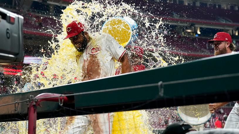Cincinnati Reds' Rece Hinds, left, is doused by teammates following the team's victory over the Colorado Rockies in a baseball game, Monday, July 8, 2024 in Cincinnati. It was Hinds' major league debut. (AP Photo/Jeff Dean)