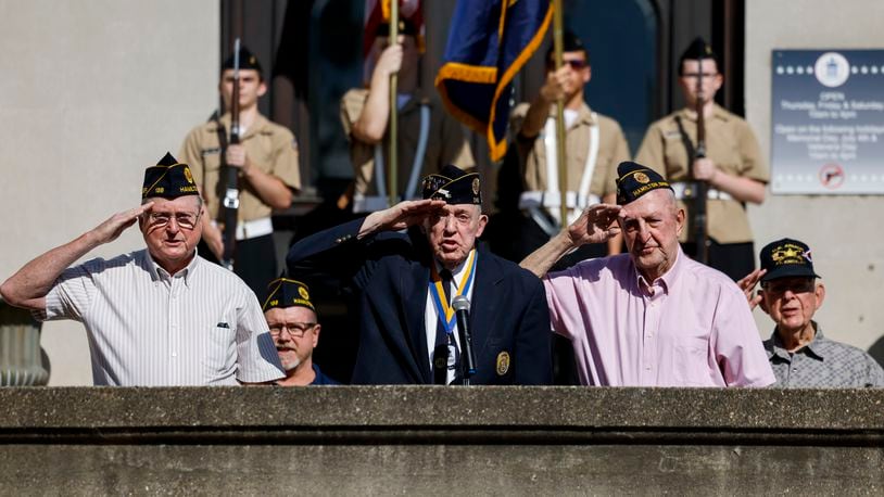 Left to right: U.S. Navy veteran Bill Harvey, U.S. Army veteran Delbert Young, U.S. Army veteran D.D. Withrow and U.S. Army veteran Lyle conn salute during a wreath laying ceremony in front of the Soldiers, Sailors and Pioneers Monument before the Memorial Day Parade Monday, May 29, 2023 in Hamilton. NICK GRAHAM/STAFF