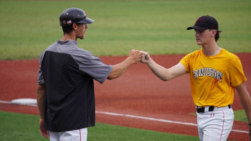 Hamilton Joes manager Tyler Thamann congratulates starting pitcher Cooper Fiehrer during a game against the Xenia Scouts on Thursday, July 4 at Foundation Field. Chris Vogt/CONTRIBUTED