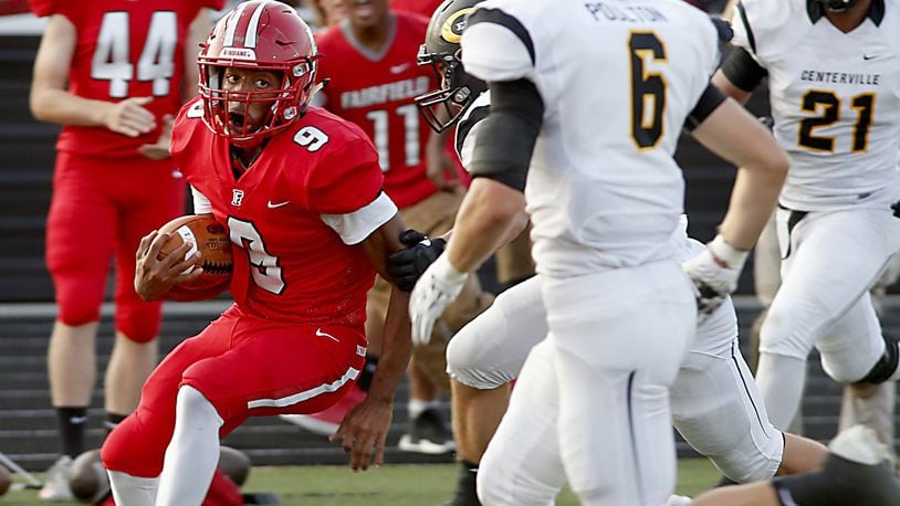 Fairfield running back Jutahn McClain eyes Centerville defensive back Riley Poulton as McClain runs for a touchdown during their game at Fairfield last Friday. The visiting Elks won 30-23. CONTRIBUTED PHOTO BY E.L. HUBBARD