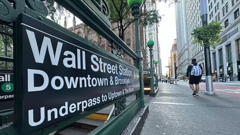 People pass the entrance for the Wall Street subway station on Tuesday, Sept. 2, 2024, in New York. (AP Photo/Peter Morgan)