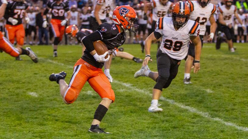 Coldwater receiver Braylen Harlamert runs for a first down against Versailles Friday night at Coldwater. Jeff Gilbert/CONTRIBUTED