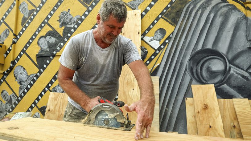 Jay McCoy puts up plywood in preparation for Hurricane Milton on Monday, Oct. 7, 2024, in New Port Richey, Fla. (AP Photo/Mike Carlson)