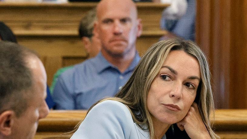 FILE — Karen Read listens to her attorney, Martin Weinberg, who was making motions to dismiss two charges against her, at Norfolk Superior Court, in Dedham, Mass., Friday, Aug. 9, 2024. (Greg Derr/The Patriot Ledger via AP, Pool, File)