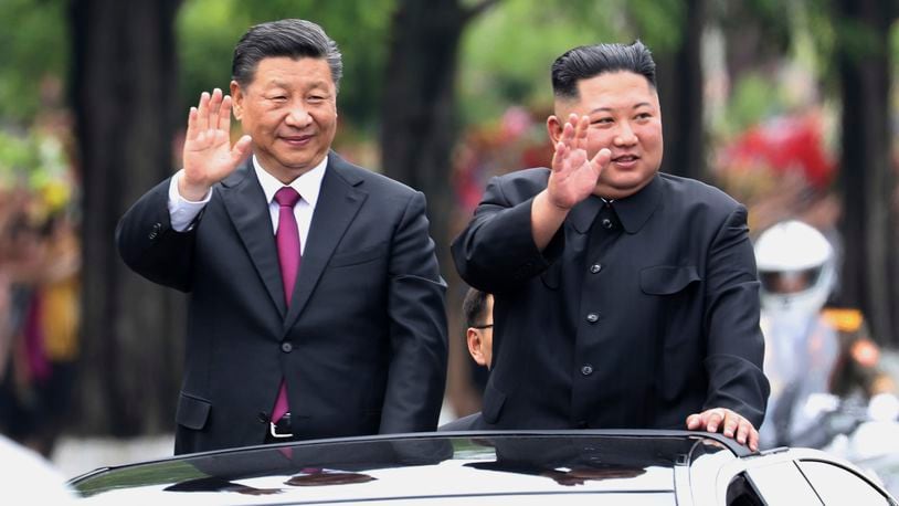 FILE - In this photo released by China's Xinhua News Agency, visiting Chinese President Xi Jinping, left, and North Korean leader Kim Jong Un wave from an open top limousine as they travel along a street in Pyongyang, North Korea, on June 20, 2019. (Ju Peng/Xinhua via AP, File)