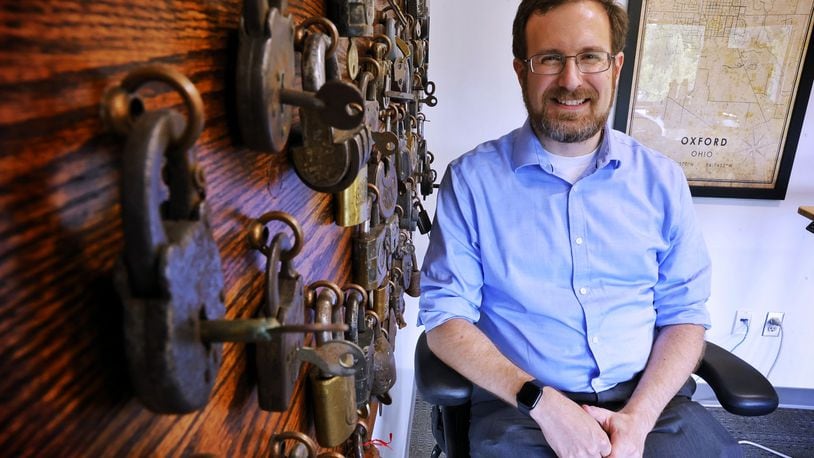 David Seidl, Miami University's vice president for information technology and chief information officer, has a unique hobby of picking locks and has a display board of  vintage locks behind his desk that his grandfather collected as a locksmith. NICK GRAHAM/STAFF