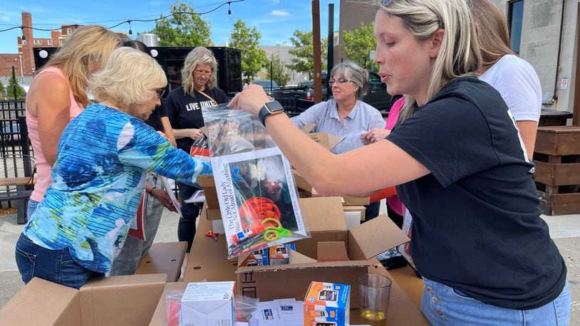 The Books and Brews event, where literacy kits will be assembled to support young children, is set for 4 to 6 p.m. Thursday, Sept. 5, at Pour House, 138 Riverfront Plaza, downtown Hamilton. Pictured is a previous time volunteers assempled literacy kits, but at Municipal Brew Works in downtown Hamilton. PROVIDED/BUTLER COUNTY UNITED WAY