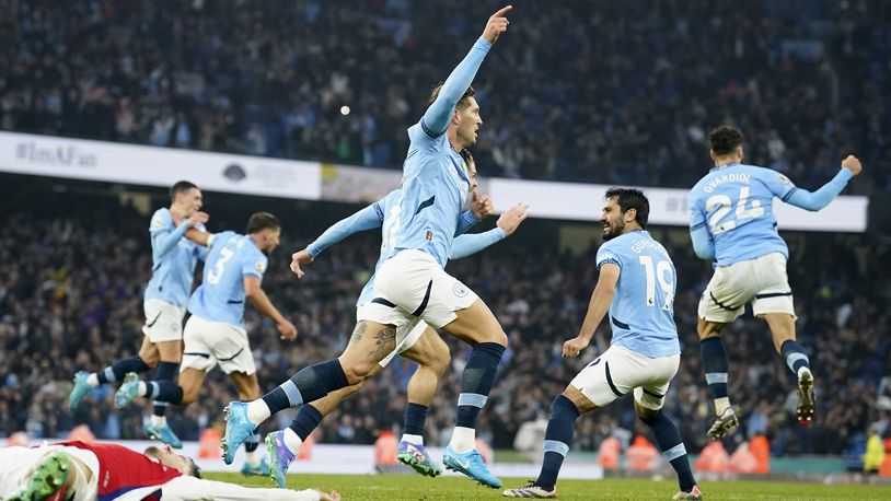 Manchester City's John Stones, center, celebrates scoring his side's second goal during the English Premier League soccer match between Manchester City and Arsenal at the Etihad stadium in Manchester, England, Sunday, Sept. 22, 2024. (AP Photo/Dave Thompson)