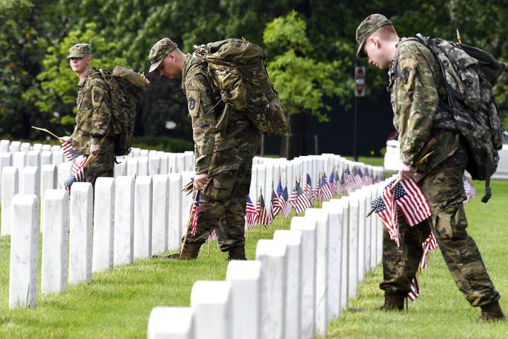 Soldiers place flags at Arlington National Cemetery for Memorial Day