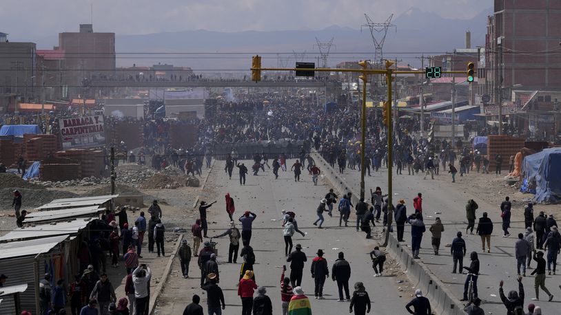 Supporters of former President Evo Morales, below, marching to La Paz to protest the government of current President Luis Arce, advance towards Arce supporters in El Alto, Bolivia, Sunday, Sept. 22, 2024. (AP Photo/Juan Karita)