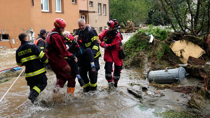 FILE - A resident is evacuated from her flooded house in Jesenik, Czech Republic, Sept. 15, 2024. (AP Photo/Petr David Josek, File)