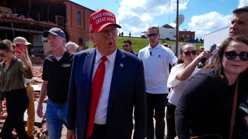 Republican presidential nominee former President Donald Trump walks outside the Chez What furniture store as he visits Valdosta, Ga., a town impacted by Hurricane Helene, Monday, Sept. 30, 2024. (AP Photo/Evan Vucci)