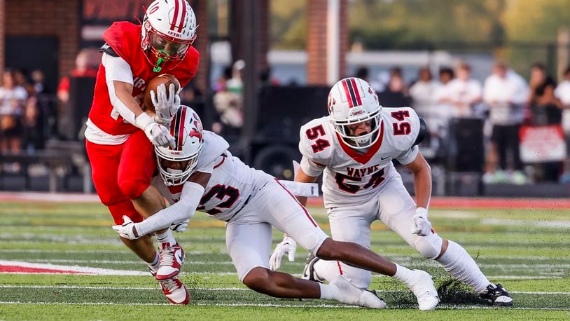 Wayne's Sean Heisle tackles Fairfield's Tyler George during their game. Wayne defeated Fairfield 31-13 on opening night of high school football Friday, Aug. 23, 2024 at Fairfield Alumni Stadium. NICK GRAHAM/STAFF