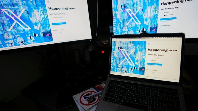 FILE - Computer monitors and a laptop display the X, formerly known as Twitter, sign-in page, July 24, 2023, in Belgrade, Serbia. (AP Photo/Darko Vojinovic, File)