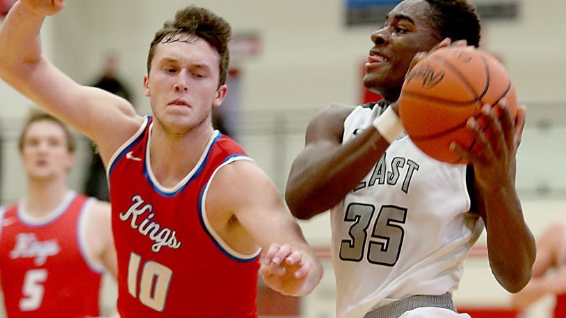 Lakota East guard Jarrett Cox drives on Kings guard Tyler Mitchell during their Division I sectional game at Lakota West on Wednesday night. CONTRIBUTED PHOTO BY E.L. HUBBARD