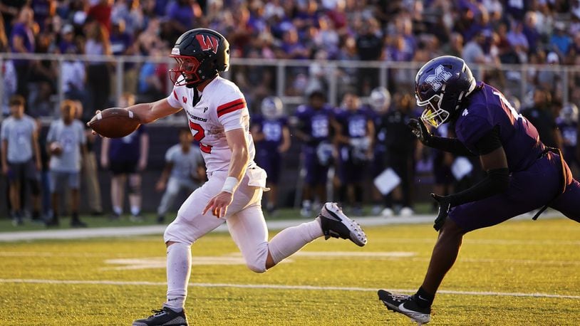 Lakota West quarterback Sam Wiles scores a rushing touchdown during Friday night's game at Middletown. Nick Graham/STAFF