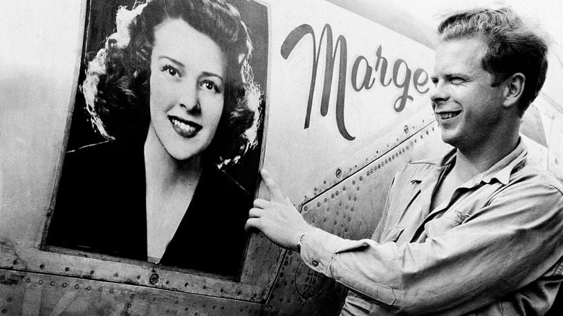 FILE - Captain Richard J. Bong, of Poplar, Wis., points to a large picture of his girl friend, Marge Vattendahl, on his Lighting P-38 fighter plane pilot stationed at a New Guinea Air Base, March 31, 1944. Searchers announced Thursday, May 23, 2024, that they've discovered what they believe is the wreckage of World War II ace Bong's plane in the South Pacific. (AP Photo, File)