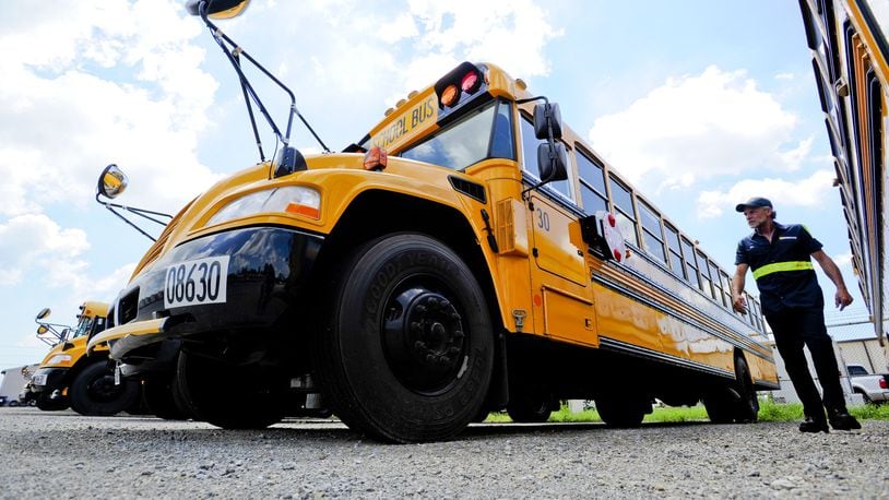 FILE PHOTO: Mechanic Tim Audia checks location of numbers on a new bus from 3019 before putting numbers on one of the five new buses they got for the 2020 year at the Petermann bus depot  in Middletown. Staff photo by Nick Graham