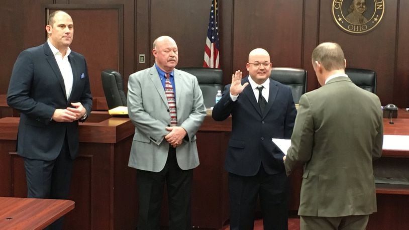 Matt Wilcher raises his hand as he is sworn-in as a member of Franklin City Council by Franklin Municipal Court Judge Ron Ruppert on Wednesday at the Franklin City Building. Returning Councilmen Michael Aldridge, left, and Denny Centers await their turn to take their oaths of office. ED RICHTER/STAFF