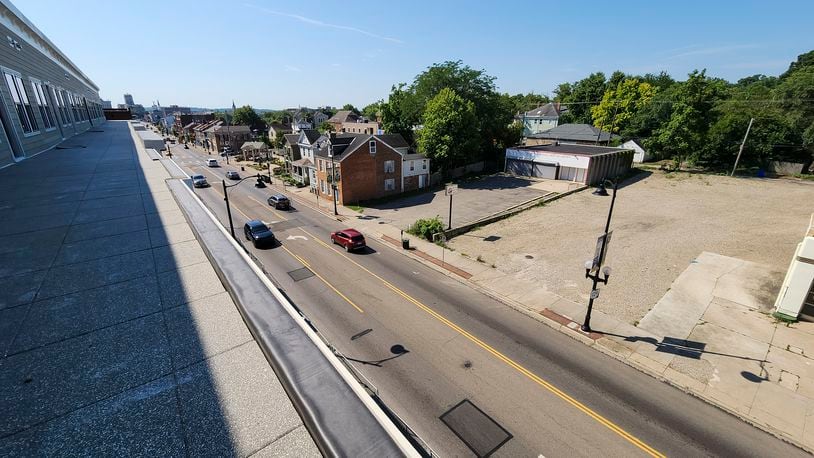 Pictured is the property where the city plans to construct a public parking lot, which is adjacent to the planned Agave & Rye restaurant location. Demolition of the former Legacy Martial Arts Academy building (center back) is expected to be razed soon. This view of Main Street from an apartment balcony at the Rossville Flats development. NICK GRAHAM/FILE