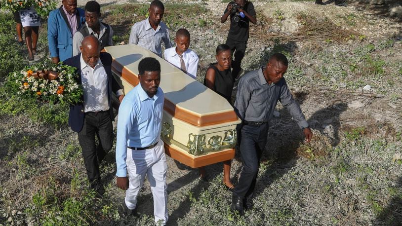 Relatives carry the coffin of Jean Louis Jeune Gracien, who was killed during an attack by armed gangs, at his funeral in Pont-Sonde, Haiti, Tuesday, Oct. 8, 2024. (AP Photo/Odelyn Joseph)