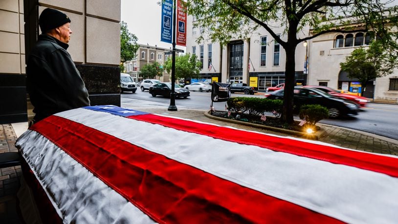 In this file photo, Robert Detzel stands watch over a flag draped casket outside the Butler County Veterans Service Commission office in Hamilton. NICK GRAHAM / STAFF